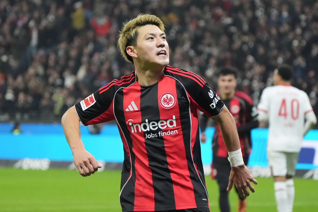 Frankfurt's Ritsu Doan celebrates after scoring the opening goal during the German Bundesliga soccer match between Eintracht Frankfurt and FC Augsburg in Frankfurt, Germany, Saturday, Dec. 13, 2025. (Marc Schueler/dpa via AP)