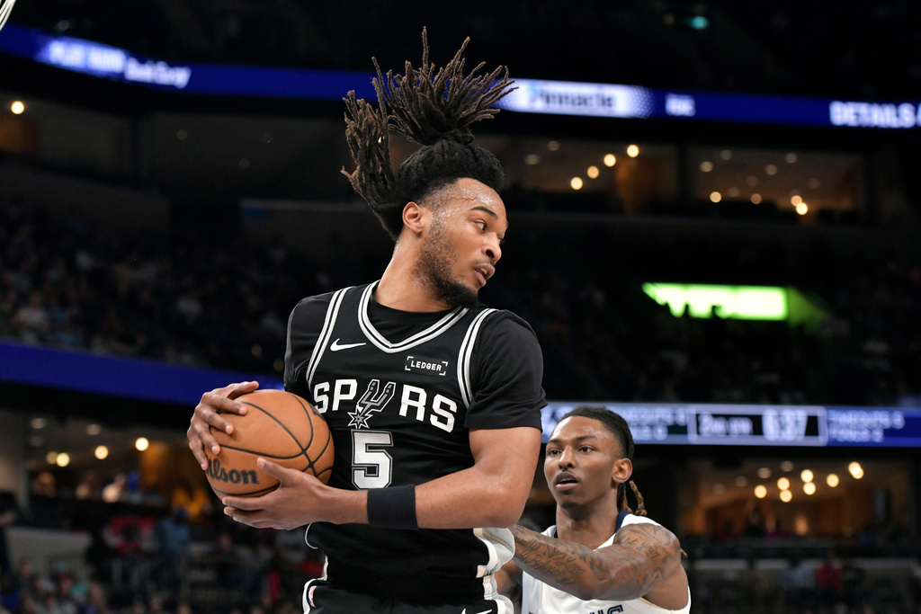 San Antonio Spurs guard Stephon Castle (5) handles the ball against Memphis Grizzlies guard Javon Small in the first half of an NBA basketball game Wednesday, March 25, 2026, in Memphis, Tenn. (AP Photo/Brandon Dill)