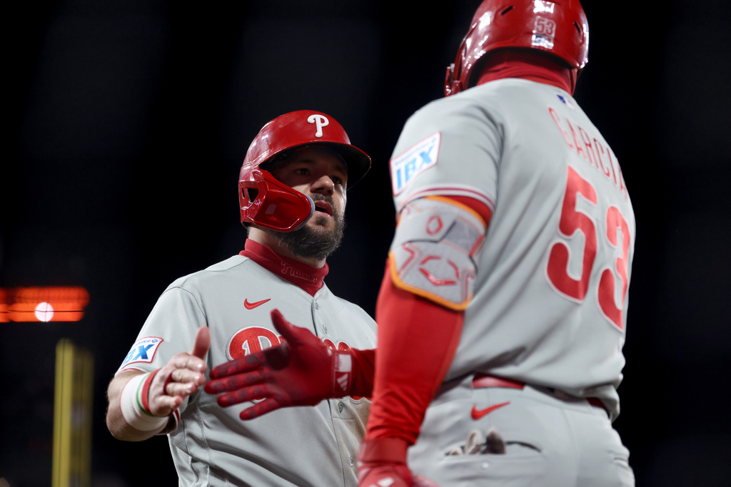 Philadelphia Phillies' Kyle Schwarber, left, is congratulated by Adolis García (53) after scoring on a double hit by Alec Bohm during the seventh inning of a baseball game against the San Francisco Giants in San Francisco, Monday, April 6, 2026. (AP Photo/Jed Jacobsohn)