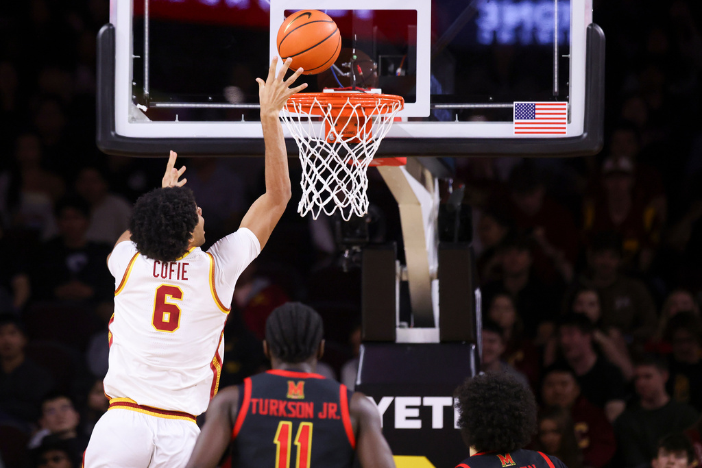 Southern California forward Jacob Cofie (6) drives to the basket as Maryland guard George Turkson Jr., center, and forward Aleks Alston, right, watch during the first half of an NCAA college basketball game, Tuesday, Jan. 13, 2026, in Los Angeles. (AP Photo/Jessie Alcheh)
