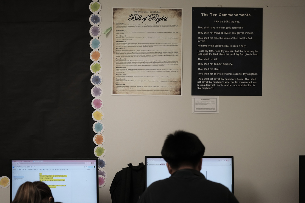 FILE - Students work under Ten Commandments and Bill of Rights posters on display in a classroom at Lehman High School in Kyle, Texas, Oct. 16, 2025. (AP Photo/Eric Gay,File)