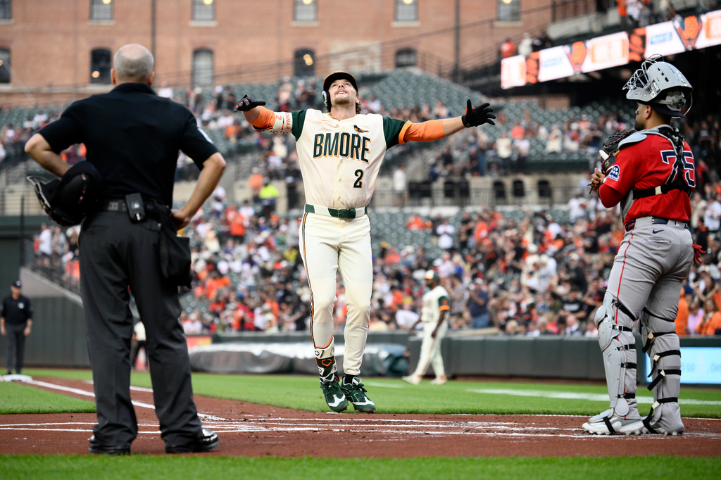 Baltimore Orioles' Gunnar Henderson (2) celebrates after his home run near Boston Red Sox catcher Carlos Narváez, right, during the first inning of a baseball game, Friday, April 24, 2026, in Baltimore. (AP Photo/Nick Wass)
