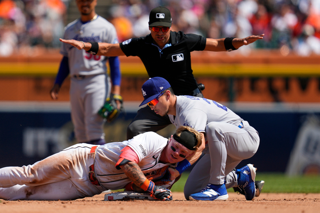Detroit Tigers' Max Clark slides safely into second base for a double ahead of the tag of Los Angeles Dodgers second baseman Tommy Edman (25) during the fifth inning of a baseball game Saturday, Aug. 29, 2026, in Detroit. (AP Photo/Paul Sancya)