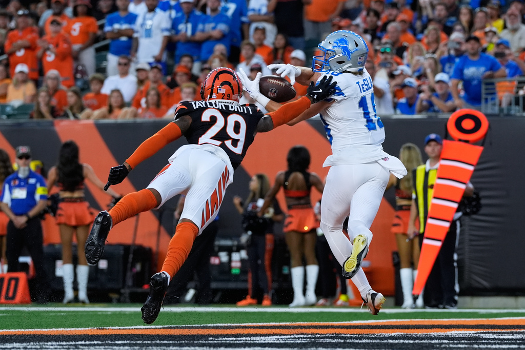 Detroit Lions wide receiver Isaac Teslaa (18) catches a 12-yard touchdown pass as Cincinnati Bengals cornerback Cam Taylor-Britt (29) defends during the second half of an NFL football game Sunday, Oct. 5, 2025, in Cincinnati. (AP Photo/Carolyn Kaster)