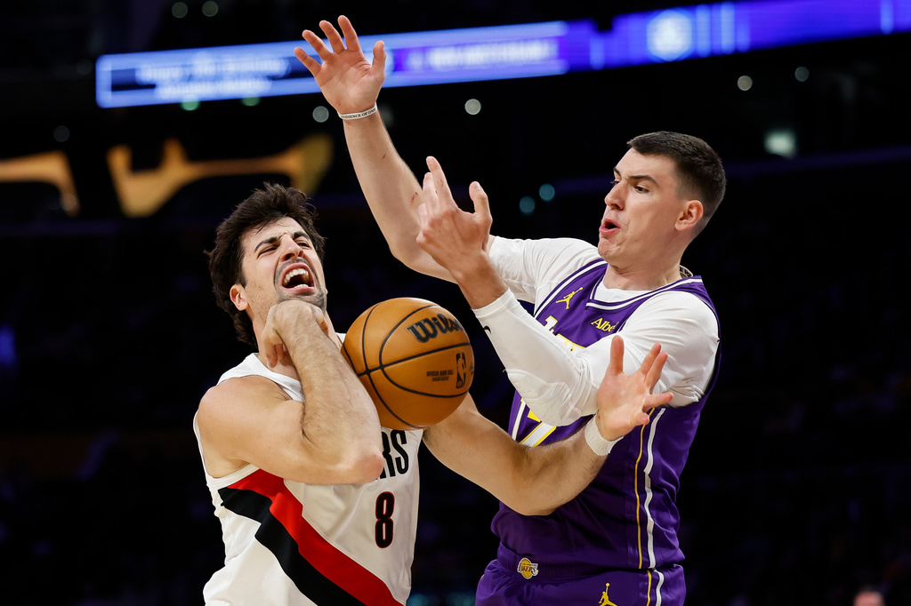 Portland Trail Blazers forward Deni Avdija (8), left, loses control of the ball while being guarded by Los Angeles Lakers forward Jake LaRavia (12), right, during the first half of an NBA basketball game Tuesday, Oct. 27, 2026, in Los Angeles. (AP Photo/Caroline Brehman)