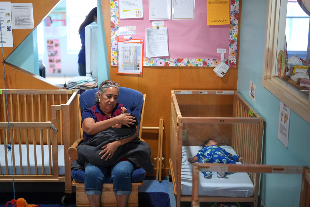 A teacher comforts a young child at a Head Start preschool in Immokalee, Fla., Thursday, Sept. 10, 2026. (AP Photo/Rebecca Blackwell)