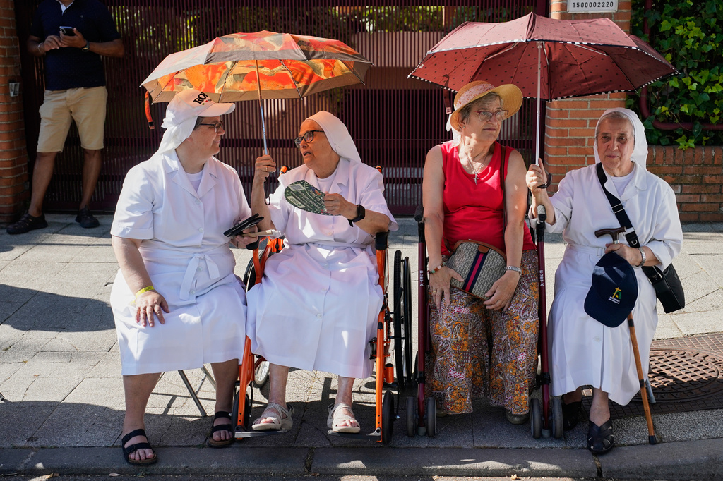 Nuns wait to greet Pope Leo XIV in Madrid, Monday, June 8, 2026. (AP Photo/Andrea Comas)