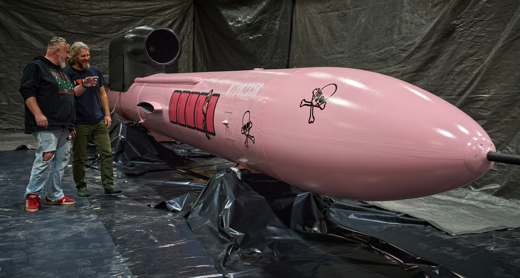 Jan Polak, right, and Martin Ondracek from the Czech organization, Weapons to Ukraine, look at a Flamingo cruise missile which was paid for by their crowdfunding campaign, at the Fire Point factory at an undisclosed location in Ukraine, Sunday, Nov. 16, 2025. (AP Photo/Efrem Lukatsky)