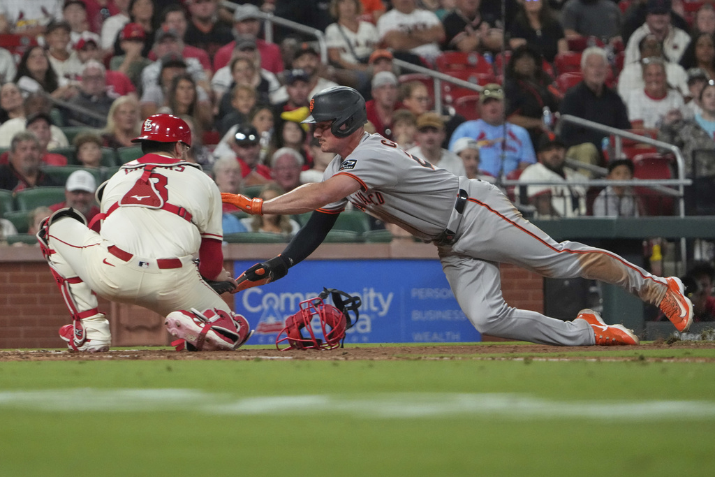 San Francisco Giants' Matt Chapman, right, is tagged out at home by St. Louis Cardinals catcher Jimmy Crooks to end the top of the sixth inning of a baseball game Saturday, Sept. 6, 2025, in St. Louis. (AP Photo/Jeff Roberson)
