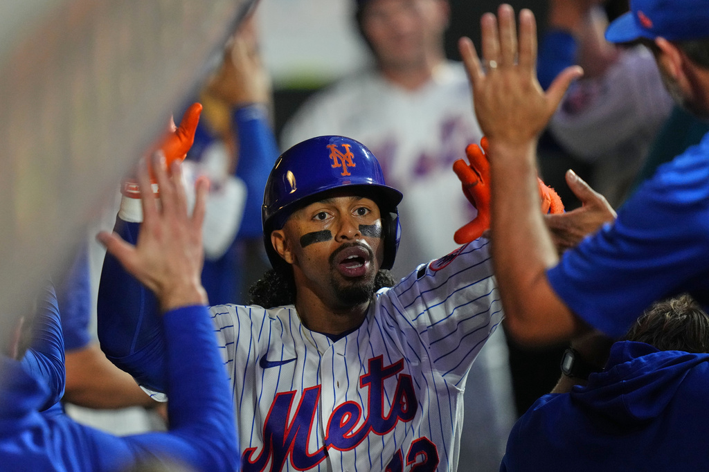 New York Mets' Francisco Lindor (12) celebrates with teammates after hitting a two-run home run during the third inning of a baseball game against the Atlanta Braves Monday, July 27, 2026, in New York. (AP Photo/Frank Franklin II)