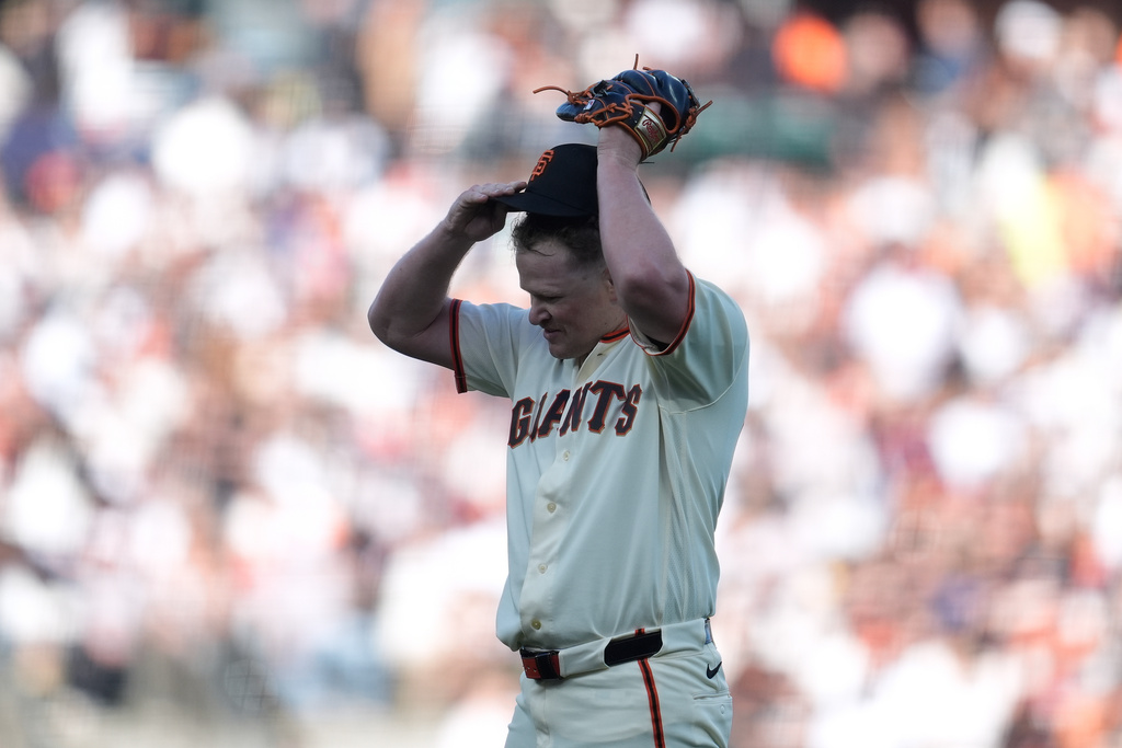 San Francisco Giants pitcher Logan Webb reacts after a two-run single hit by New York Yankees' Ryan McMahon during the second inning of a baseball game in San Francisco, Wednesday, March 25, 2026. (AP Photo/Jeff Chiu)