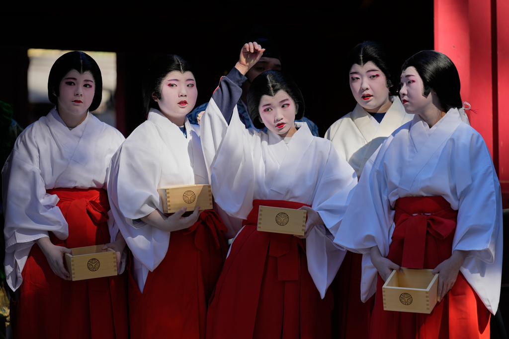 Local students dressed as shrine maidens participate in the annual Bean Throwing Festival in Hakone, Japan, Tuesday, Feb. 3, 2026. (AP Photo/Eugene Hoshiko)