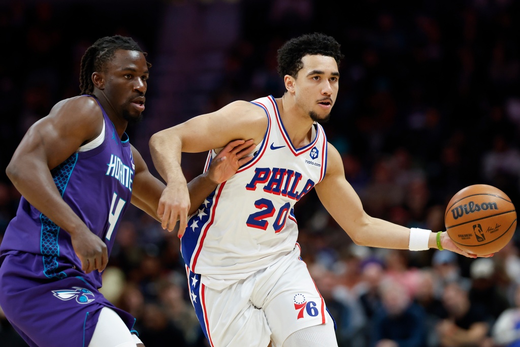 Philadelphia 76ers guard Jared McCain (20) moves the ball as Charlotte Hornets guard Sion James defends during the second half of an NBA basketball game in Charlotte, N.C., Monday, Jan. 26, 2026. (AP Photo/Nell Redmond)
