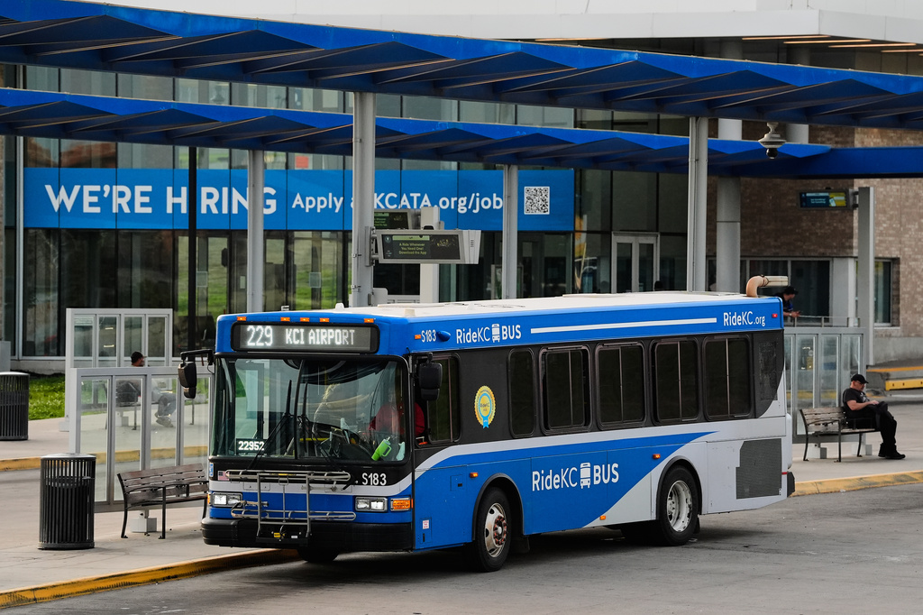 A bus waits for passengers at a transit center Friday, June 5, 2026, in Kansas City, Mo. (AP Photo/Charlie Riedel)