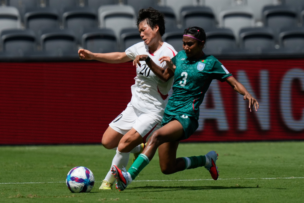 Bangladesh's Shamsunnahar Sr., right, and North Korea's Chae Un Yong compete for the ball during their Women's Asian Cup Soccer match in Sydney, Friday, March 6, 2026. (AP Photo/Rick Rycroft)