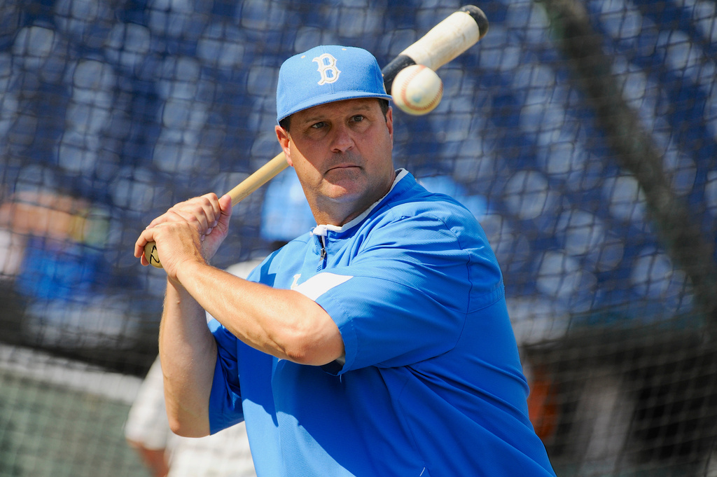 FILE - In this June 14, 2013, file photo, UCLA coach John Savage eyes the ball during NCAA college baseball practice at TD Ameritrade Park in Omaha, Neb. (AP Photo/Eric Francis, File)