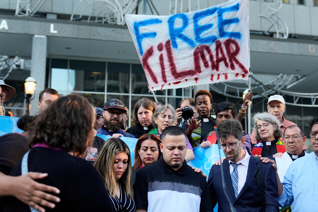 FILE - Jennifer Vasquez Sura, front left, her husband Kilmar Abrego Garcia, front center, and Attorney Simon Sandoval-Moshenberg, front right, attend a protest rally at the Immigration and Customs Enforcement field office in Baltimore, Monday, Aug. 25, 2025, to support Kilmar Abrego Garcia. (AP Photo/Stephanie Scarbrough, File)