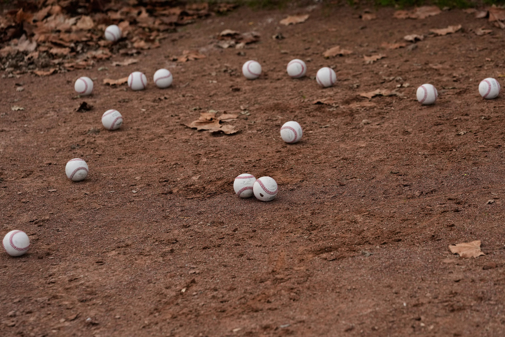 Baseballs are scattered on the ground as Daulton Jefferies works out at Heather Farms Park in Walnut Creek, Calif., Saturday, Dec. 13, 2025. (AP Photo/Godofredo A. Vásquez)
