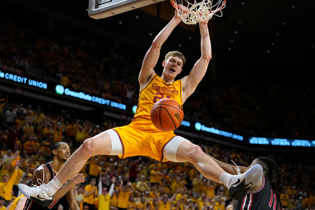 Iowa State forward Dominykas Pleta dunks over Houston forward Joseph Tugler (11) during the second half of an NCAA college basketball game, Monday, Feb. 16, 2026, in Ames, Iowa. (AP Photo/Charlie Neibergall)