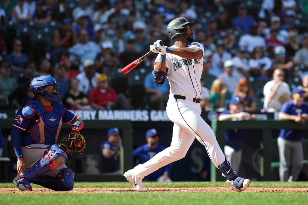 Seattle Mariners Lazaro Montes follows through on a double as Texas Rangers catcher Elias Díaz looks on during the seventh inning of a baseball game, Wednesday, Sept. 9, 2026, in Seattle. (AP Photo/Jason Redmond)