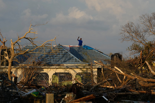 A man searches for cell signal from the roof of his house flooded and damaged by Hurricane Melissa in Black River, Jamaica, Thursday, Oct. 30, 2025. (AP Photo/Matias Delacroix) A man searches for cell signal from the roof of his house flooded and damaged by Hurricane Melissa in Black River, Jamaica, Thursday, Oct. 30, 2025. (AP Photo/Matias Delacroix)