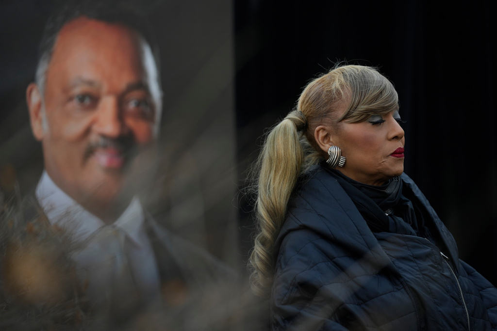 Santita Jackson stands near a picture of her father, the Rev. Jesse Jackson, during a news conference outside the family home Wednesday, Feb. 18, 2026, in Chicago. (AP Photo/Erin Hooley)