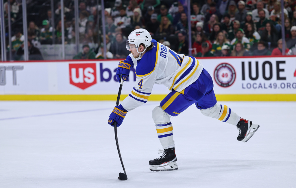 Buffalo Sabres defenseman Bowen Byram passes the puck against the Minnesota Wild during the third period of an NHL hockey game Saturday, Nov. 29, 2025, in St. Paul, Minn. (AP Photo/Adam Bettcher)