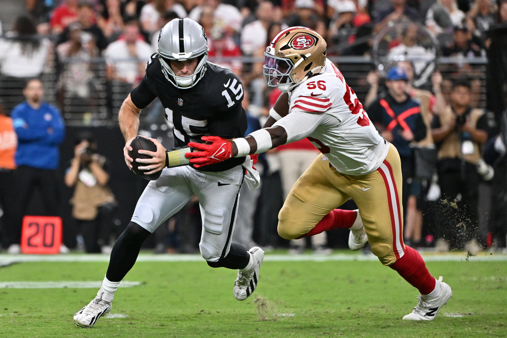 San Francisco 49ers defensive end Keion White (56) sacks Las Vegas Raiders quarterback Fernando Mendoza (15) during the first half of an NFL preseason football game, Thursday, Aug. 27, 2026}, in Las Vegas. (AP Photo/David Becker)