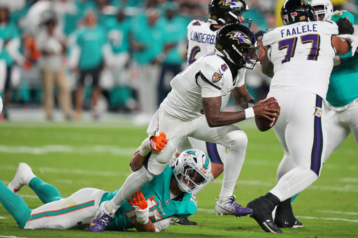 Baltimore Ravens quarterback Lamar Jackson (8) breaks free from the tackle of Miami Dolphins linebacker Jaelan Phillips (15) during the first half of an NFL football game, Thursday, Oct. 30, 2025, in Miami Gardens, Fla. (AP Photo/Lynne Sladky) Baltimore Ravens quarterback Lamar Jackson (8) breaks free from the tackle of Miami Dolphins linebacker Jaelan Phillips (15) during the first half of an NFL football game, Thursday, Oct. 30, 2025, in Miami Gardens, Fla. (AP Photo/Lynne Sladky)