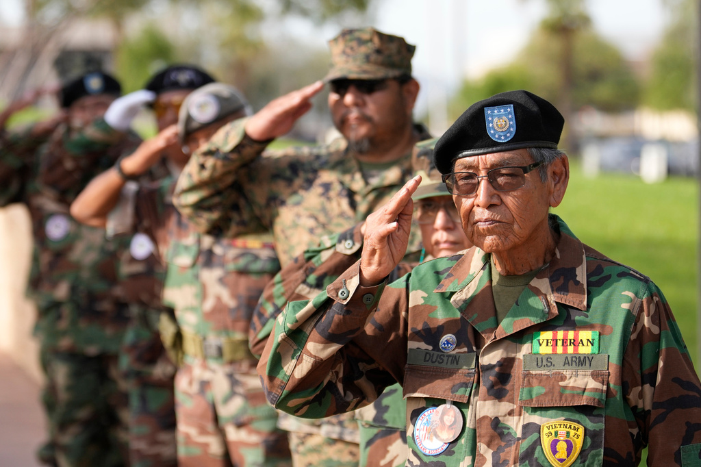Members of the San Carlos Apache Veterans Association take part in a ceremony on Navajo Code Talkers Day, Friday, Aug. 14, 2026, in Phoenix. (AP Photo/Ross D. Franklin)