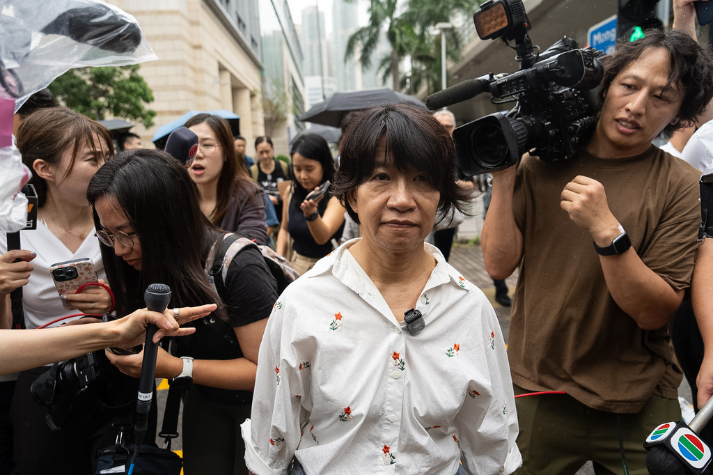 Elizabeth Tang, wife of pro-democracy activist Lee Cheuk-yan, leaves West Kowloon Magistrates' Courts in Hong Kong, Friday, Aug. 21, 2026. (AP Photo/Chan Long Hei)