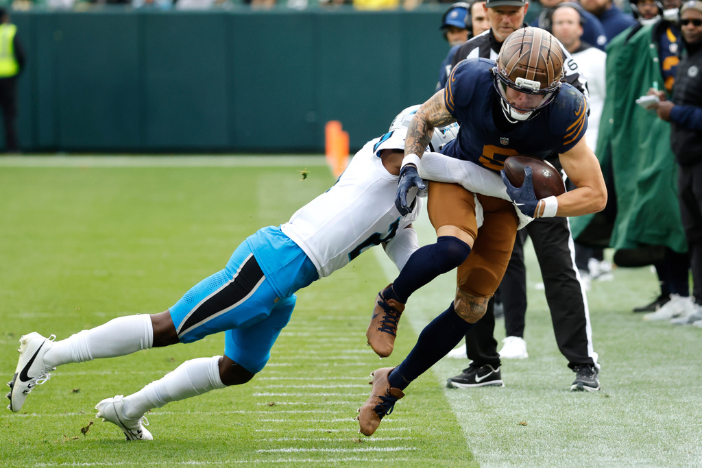 Carolina Panthers cornerback Mike Jackson, left, tackles Green Bay Packers wide receiver Christian Watson, right, during the second half of an NFL football game Sunday, Nov. 2, 2025, in Green Bay, Wis. (AP Photo/Mike Roemer)