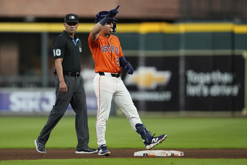 Houston Astros Ramón Urías celebrates after a single, and then advancing to second on a throwing error by Baltimore Orioles starting pitcher Brandon Young during the eighth inning of a baseball game in Houston, Friday, Aug. 15, 2025. (AP Photo/Ashley Landis)