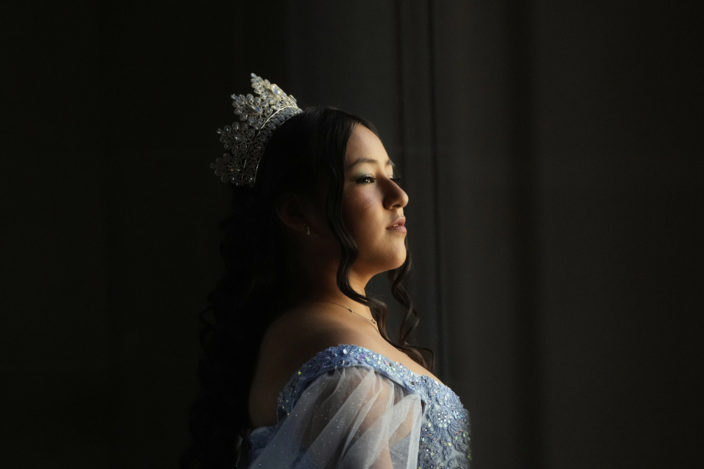 Abbie Gonzalez poses for her quinceañera portrait session at City Hall in San Francisco, Monday, Aug. 25, 2025. (AP Photo/Jeff Chiu)
