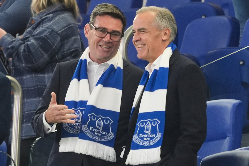 Britain's Prime Minister Andy Burnham, left, and Canada's Prime Minister Mark Carney attend the League Cup third round round soccer match between Everton and Wolverhampton Wanderers, Wednesday, Sept. 16, 2026, in Liverpool, England. (Peter Byrne/PA via AP)