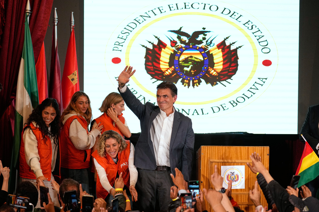 Presidential candidate Rodrigo Paz waves to supporters after preliminary results showed him leading in the presidential runoff election in La Paz, Bolivia, Sunday, Oct. 19, 2025. (AP Photo//Natacha Pisarenko)