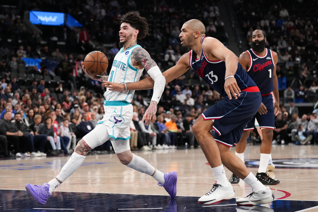 Charlotte Hornets guard LaMelo Ball (1) drives to the basket past Los Angeles Clippers guard/forward Nicolas Batum (33) during the second half of an NBA basketball game Monday, Jan. 12, 2026, in Inglewood, Calif. (AP Photo/Jae C. Hong)