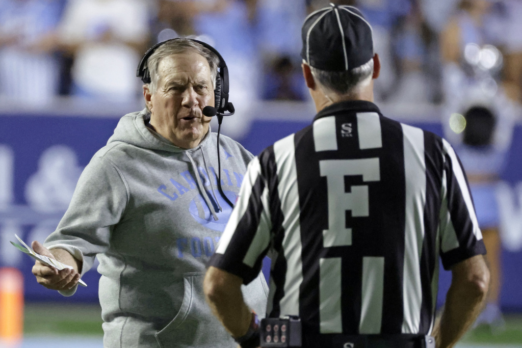 North Carolina head coach Bill Belichick, left, discusses a call with an official, right, during the second half of an NCAA college football game against TCU, Monday, Sept. 1, 2025, in Chapel Hill, N.C. (AP Photo/Chris Seward)