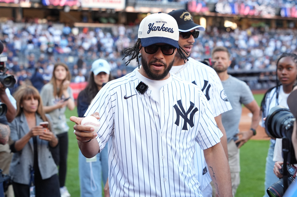 New York Knicks' Jalen Brunson, left, and Josh Hart leave the field after throwing out a ceremonial first pitch before a baseball game between the Chicago White Sox and the New York Yankees Wednesday, June 17, 2026, in New York. (AP Photo/Frank Franklin II)