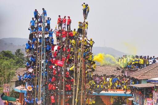 Rayba Devi Rave Villagers compete to erect huge bamboo poles at an Indian folk festival ...