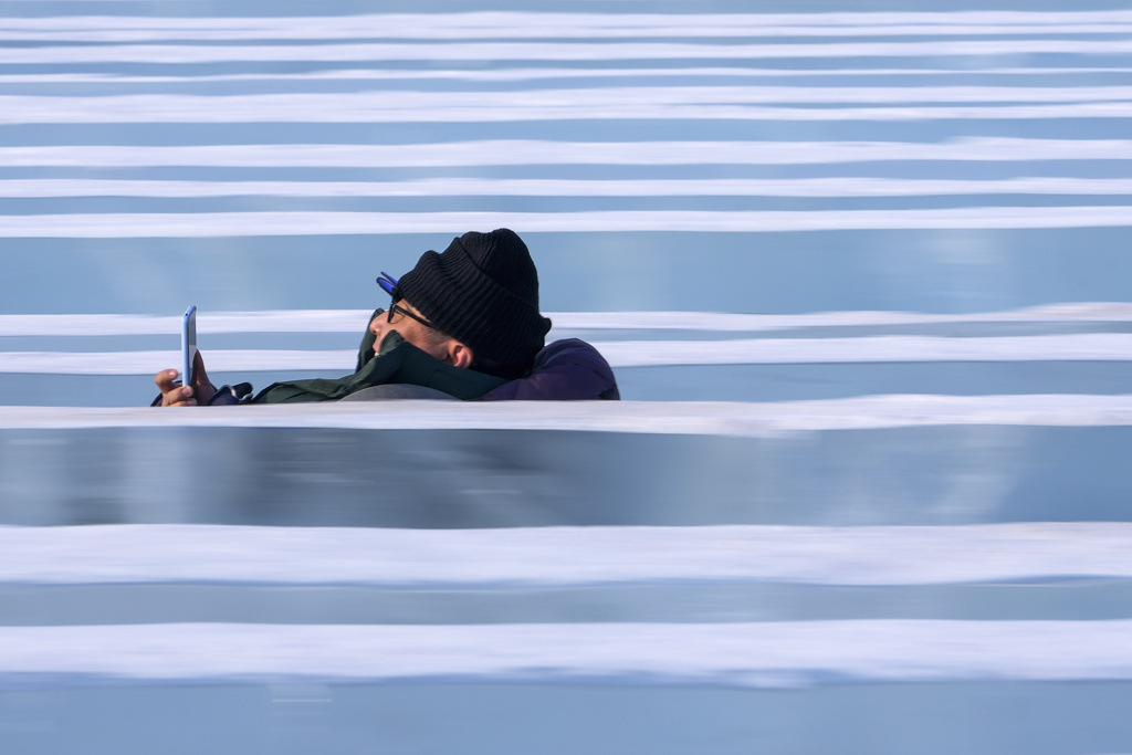 A man slides down blocks of ice at the Harbin Ice and Snow World in Harbin in China's Heilongjiang province on Monday, Jan. 6, 2025. (AP Photo/Andy Wong)