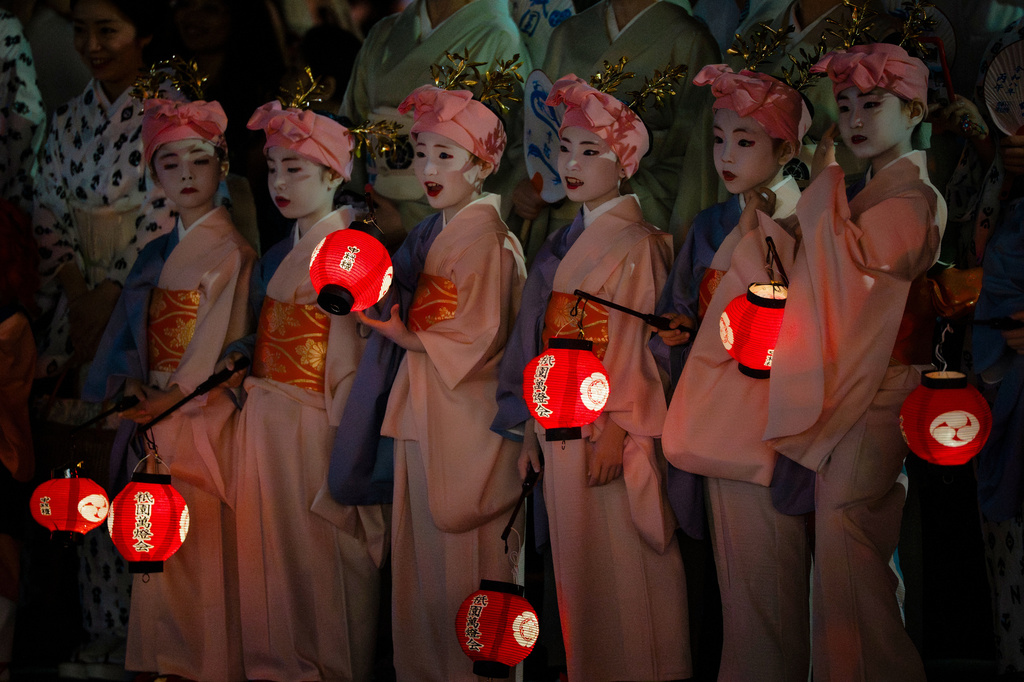 Young women dressed in traditional attire take part in the "Mikoshi Arai" purification ritual ahead of the Gion Matsuri festival in Kyoto, western Japan, Friday, July 10, 2026. (AP Photo/Fred Mery)