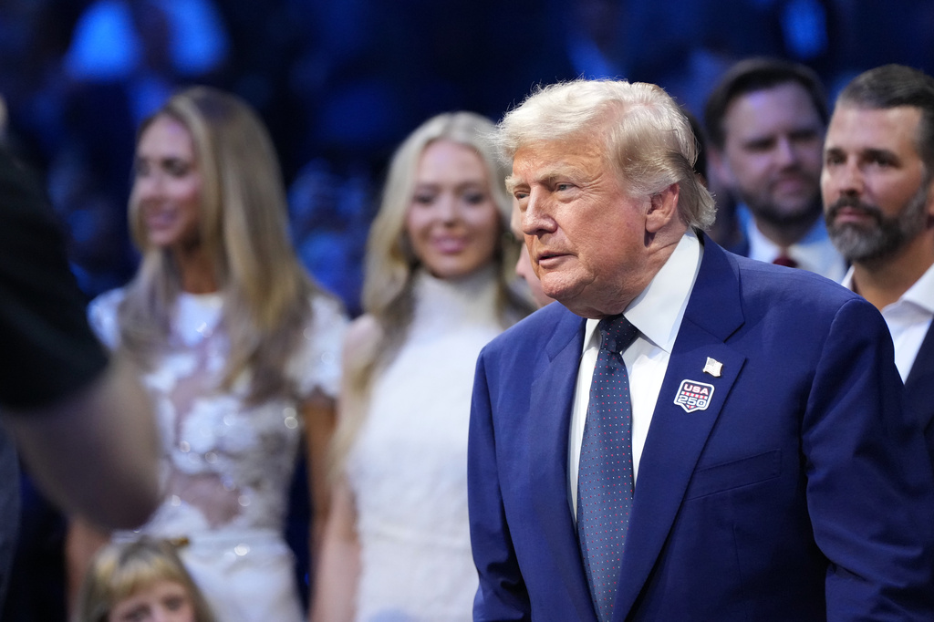 President Donald Trump attends the UFC Freedom 250 on the South Lawn of the White House, Sunday, June 14, 2026, in Washington with Lara Trump, Tiffany Trump and Donald Trump Jr. (AP Photo/Alex Brandon)