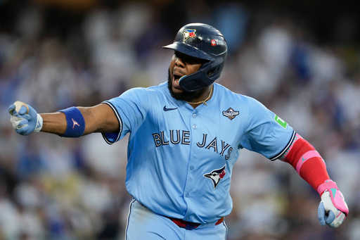 Toronto Blue Jays' Vladimir Guerrero Jr. points to his dugout after hitting a two run against the Los Angeles Dodgers during the third inning in Game 4 of baseball's World Series, Tuesday, Oct. 28, 2025, in Los Angeles. (AP Photo/Ashley Landis) Toronto Blue Jays' Vladimir Guerrero Jr. points to his dugout after hitting a two run against the Los Angeles Dodgers during the third inning in Game 4 of baseball's World Series, Tuesday, Oct. 28, 2025, in Los Angeles. (AP Photo/Ashley Landis)