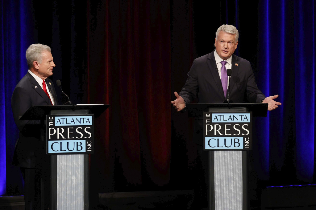 U.S. Rep. Mike Collins, R-Jackson, responds to a question from U.S. Rep. Buddy Carter, R-St. Simons Island, during the Atlanta Press Club's Republican Loudermilk-Young debate at Georgia Public Broadcasting in Midtown, Atlanta, on Sunday, April 26, 2026. (Miguel Martinez/Atlanta Journal-Constitution via AP)