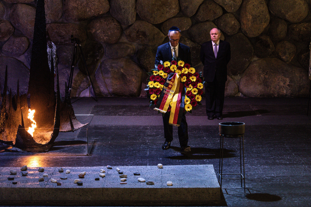 German Chancellor Friedrich Merz lays a wreath at the Hall of Remembrance during his visit to the Yad Vashem Holocaust Memorial Museum in Jerusalem, Sunday, Dec. 7, 2025. (John Wessels, Pool Photo via AP)