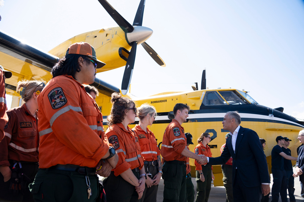 Ontario Wildland Firefighters greet Prime Minister Mark Carney at the Thunder Bay Fire Management Centre in Thunder Bay, Ontario, Canada, on Thursday, Sept. 3, 2026. (David Jackson/The Canadian Press via AP)