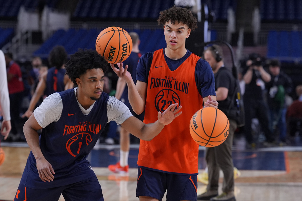Illinois' Brandon Lee (1) knocks the ball away from teammate Keaton Wagler, right, during practice ahead of a national semifinal NCAA college basketball tournament game against UConn at the Final Four, Friday, April 3, 2026, in Indianapolis. (AP Photo/Michael Conroy)