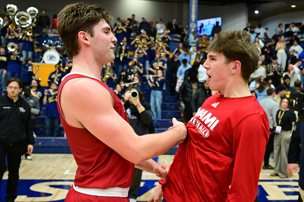 Miami guard Peter Suder, left, celebrates with Miami guard Brady Ganley, right, after Maimi defeated Kent State in an NCAA college basketball game, Tuesday, Jan. 20, 2026, in Kent, Ohio. (AP Photo/David Dermer)