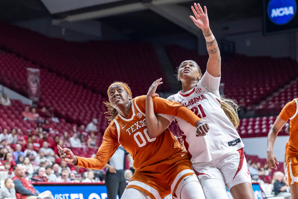 Texas center Kyla Oldacre (00) and Alabama forward Essence Cody (21) fight for position on a free throw during the second half of an NCAA college basketball game Sunday, March 1, 2026, in Tuscaloosa, Ala. (AP Photo/Vasha Hunt)